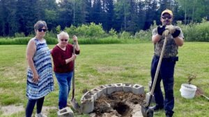 Leanne Nicholson, Terri Bell, and Pat Daignault spent the afternoon at Dyment Recreation Hall Park in Melgund Township, Northwestern Ontario, taking part in a hands-on community effort to strengthen local recreation space through garden development and tree planting.
