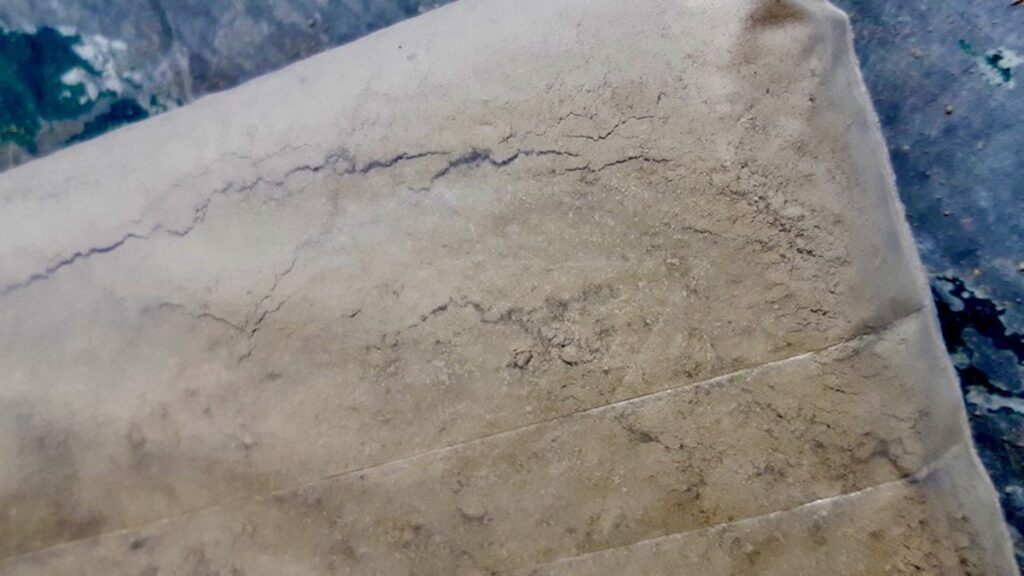 We're going to do some of our pottery and ceramics programming in the fall, so we want to save some. We crushed our dried clay down to a fine powder and bagged it for later use.